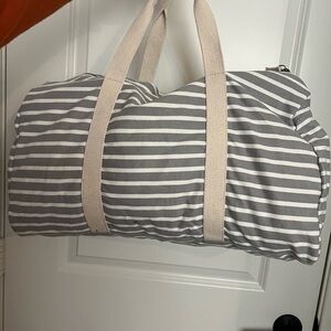 White and gray duffle luggage bag